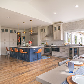 Transitional kitchen remodel in Chanhassen MN with blue island, quartz countertops, and gold pendant lighting